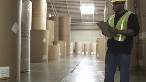 Jib shot of a warehouse worker directing a forklift Stock-Footage 76224325