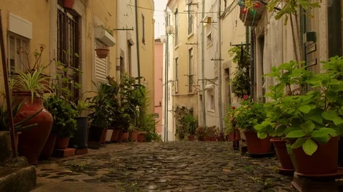 Jib style move up of narrow steep backstreet in Alfama district, Lisbon Stock-Footage 116170277