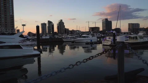 Jib Up Sun Set Over Baltimore City Skyline and Boats from Pier in Harbor  Stock Footage 96045749