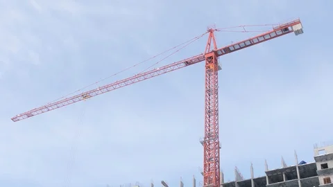 Jib-type slewing crane with arrow above house construction Stock Footage 124299244