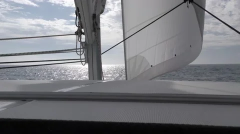 The jib under sail looking foward on catamaran from cabin top with mast Stock Footage 67956848