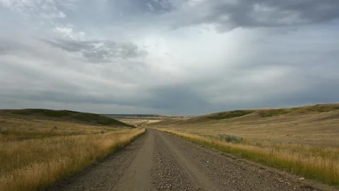 Jiggling footage as camera bounces while driving along dirt road through fall ba Stock Footage 295077708