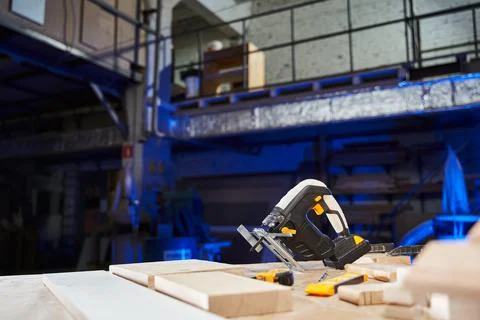 Jigsaw with battery on a workbench in a working studio Stock Photos