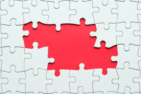 Jigsaw puzzle game piece on red background for business theme design Stock Photos