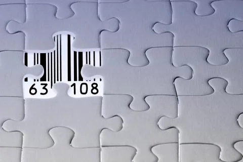Jigsaw puzzle, the last missing piece revealing a barcode with numbers Stock Photos