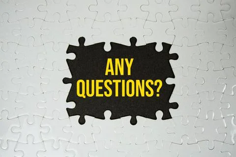 Jigsaw puzzle with a missing piece with "Any Questions?" on navy blue backg.. Stock Photos