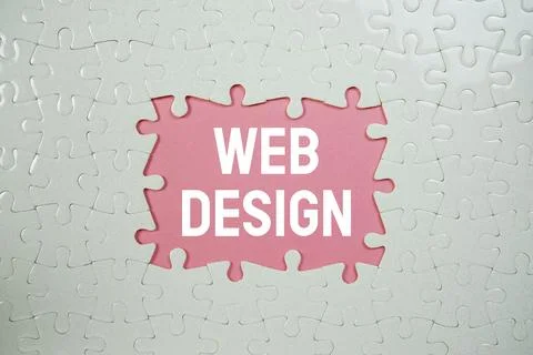 Jigsaw puzzle with a missing piece with "Web Design" on pink background Stock Photos