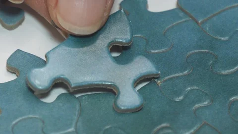 Jigsaw puzzle - one piece is inserted then the puzzle is completed 4K Stock Footage 129859768