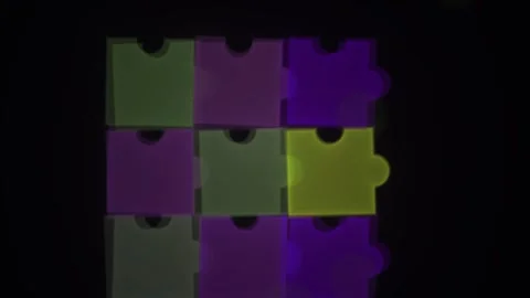 Jigsaw puzzle pieces in different colors on black background. Stock Footage 335531424