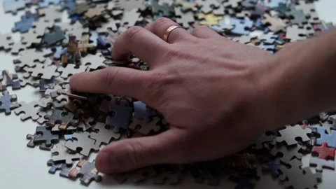 Jigsaw puzzle pieces falling down in slow motion. Stock Footage 130905523