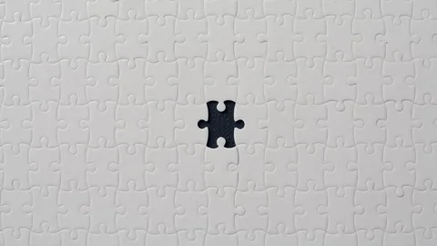 Jigsaw puzzle placed black backdrop closeup. Incomplete unfinished brain teaser Stock Footage 332307989