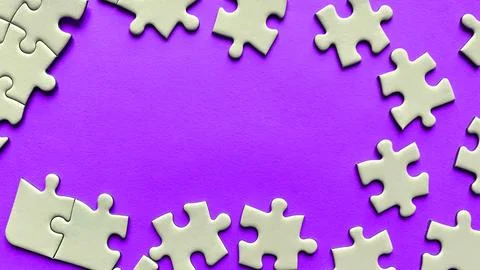 Jigsaw puzzle on purple background with customizable space for text or idea.. Stock Photos