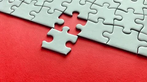 Jigsaw puzzle on red background with customizable space for text or ideas. .. Stock Photos