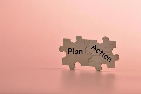 Jigsaw puzzle with text PLAN and ACTION. Copy space Stock Photos