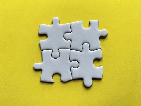 Jigsaw puzzle on yellow background with customizable space for text or idea.. Stock Photos