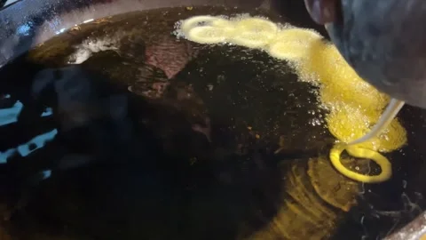 Jilapi being made at the fair Stock Footage 313503477