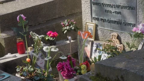Jim Morrison Grave with Flowers at Pere Lachaise Cemetery Tilt Up Stock Footage 337959016