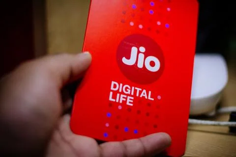 Jio SIM cards in hand with every JioFi or 4G smartphone Stock Photos