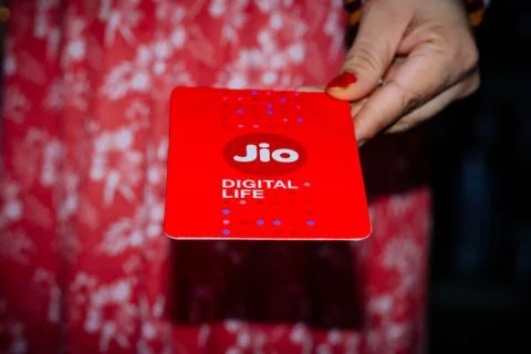 Jio SIM cards in hand with every JioFi or 4G smartphone Stock Photos