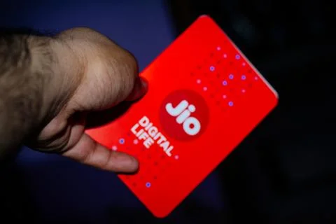 Jio SIM cards in hand with every JioFi or 4G smartphone Stock Photos