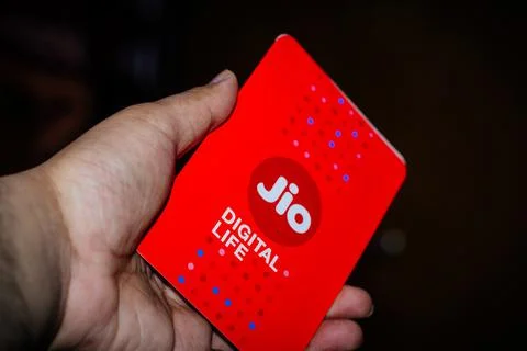 Jio SIM cards in hand with every JioFi or 4G smartphone Stock Photos