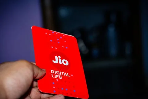 Jio SIM cards in hand with every JioFi or 4G smartphone Stock Photos