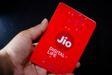 Jio SIM cards in hand with every JioFi or 4G smartphone Stock Photos