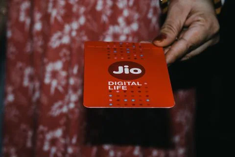 Jio SIM cards in hand with every JioFi or 4G smartphone Stock Photos