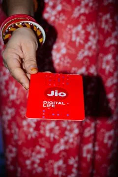 Jio SIM cards in hand with every JioFi or 4G smartphone Stock Photos