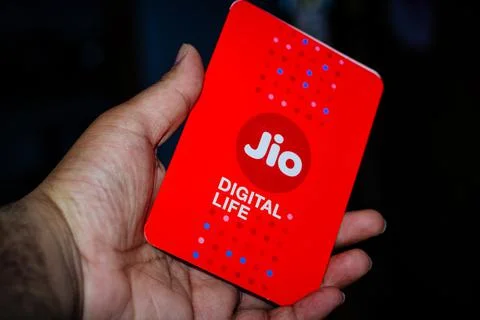 Jio SIM cards in hand with every JioFi or 4G smartphone Stock Photos