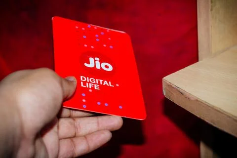 Jio SIM cards in hand with every JioFi or 4G smartphone Stock Photos
