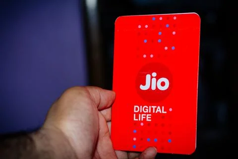 Jio SIM cards in hand with every JioFi or 4G smartphone Stock Photos