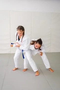 Jiu jitsu students practicing standing arm control on tatami Stock-Fotos