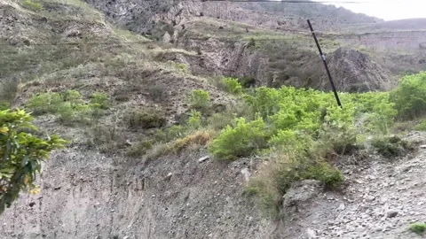 Jiuzhaigou Valley: Rocky Hillside With Sparse Shrubs And Power Lines Видео 336297384
