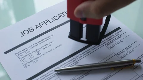 Job application document rejected, hand stamping seal on official paper, hiring 库存影片 99012973