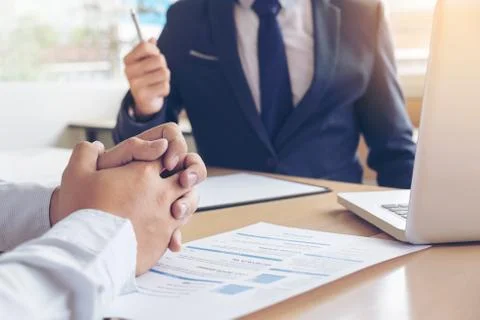 Job application interview. Executive manager hold up pen to Sign Approval, Cl Stock Photos