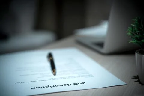 Job Description document with Pen on the table. Stock Photos