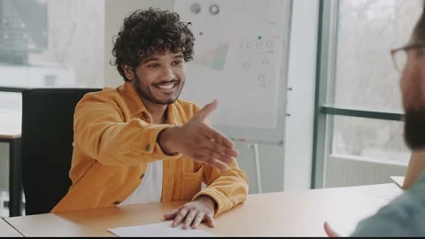 Job interview and hiring concept. HR holds resume in hands and communicates with Stock Footage 237167491