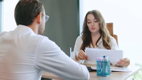 Job interview taking place in a modern office setting with a male candidate and Video stock 315754679
