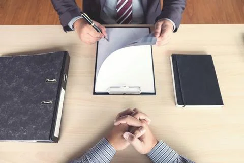 Job interview, Young attractive executives man reading his resume, work his.. Foto stock