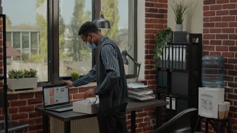 Jobless man gathering things in box after getting fired from work Stock Footage 169021502