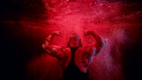 Jock is plunging in depth of pool or aquarium with red lights, power and Video stock 170640199