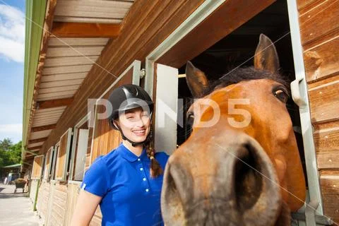 Jockey girl with her funny horse looking at camera Stock Photos