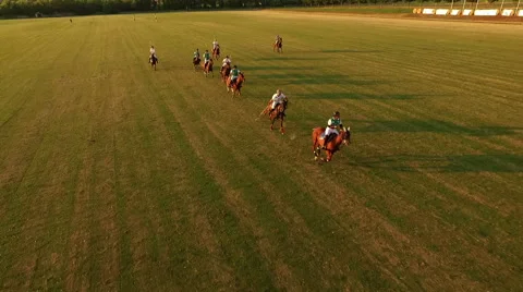 Jockeys chasing the ball. Slight slow motion. Aerial. N Polo challenge, sunset. Video stock 64637638