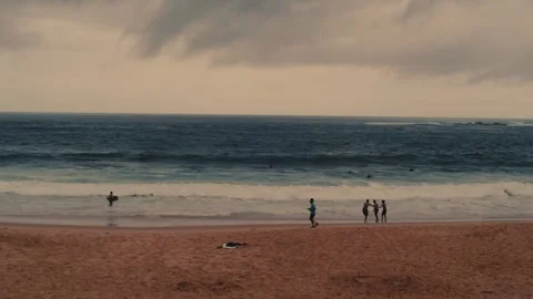 Jogger running across the beach on a cloudy day Video stock 256145049