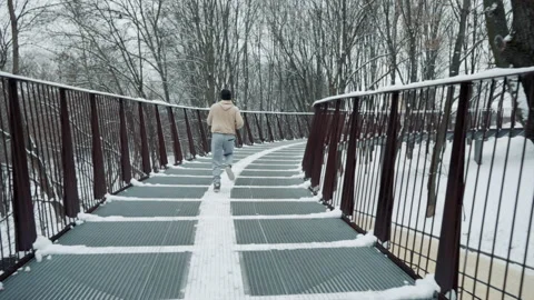 Jogger running along bridge in winter Stock Footage 147252033