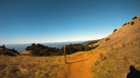 Jogger running along a hilly path. Stock Footage 88404316
