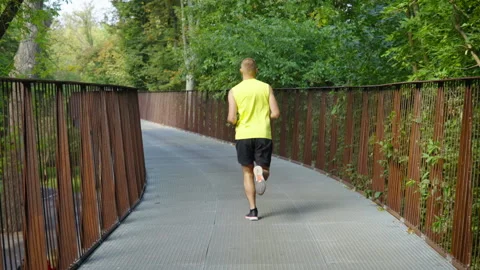 Jogger running on bridge in summer Stock Footage 162463781
