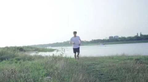 Jogger running at the river Stock Footage 40770507