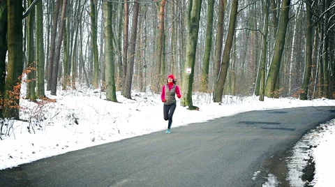 Jogger running on the road at winter, steady, slow motion shot at 240fps Stock Footage 46884155